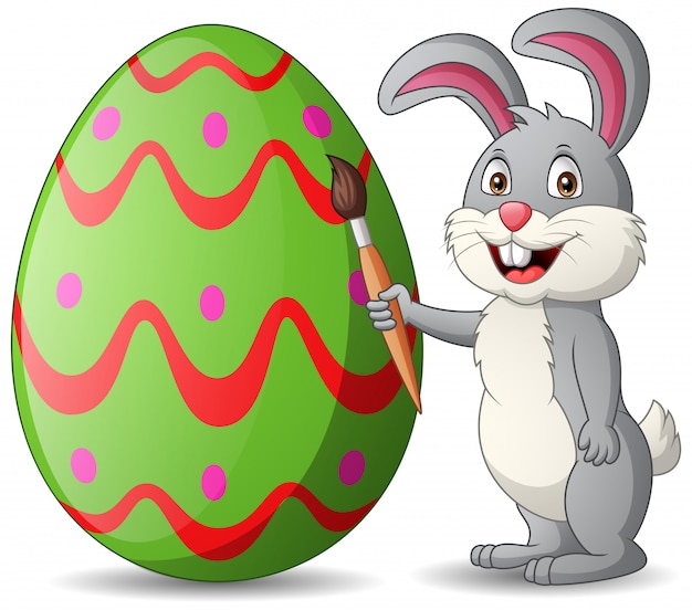 Cartoon rabbit is painting eggs. illustration