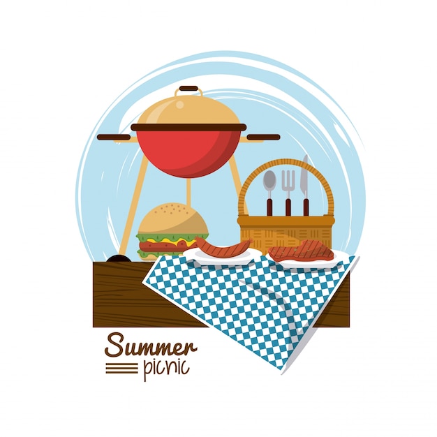 charcoal grill and burger and picnic basket over tablecloth