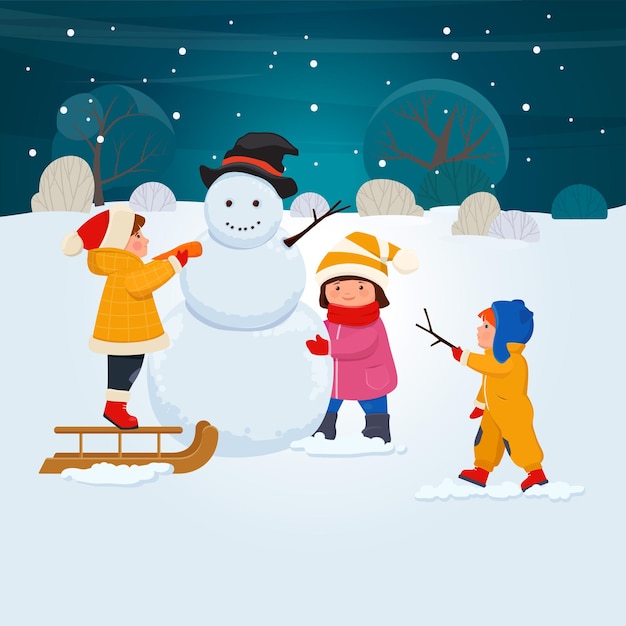 children in winters clothes make a snowman in winter