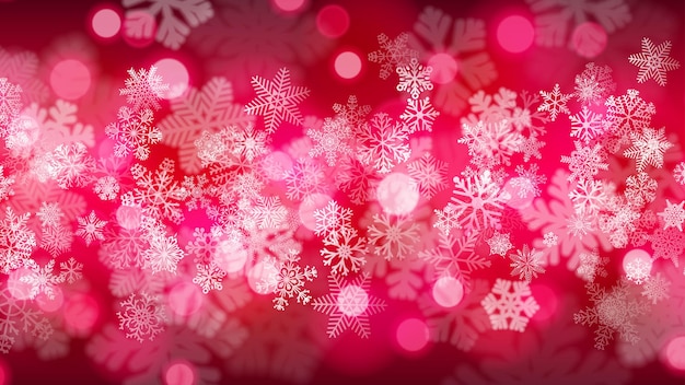 深紅色のボケ効果を持つ大小の雪片のクリスマスの背景