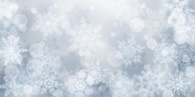 Christmas background of blurry snowflakes in gray colors