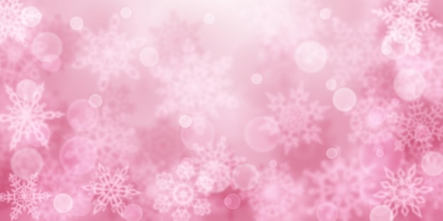 Christmas background of blurry snowflakes in pink colors