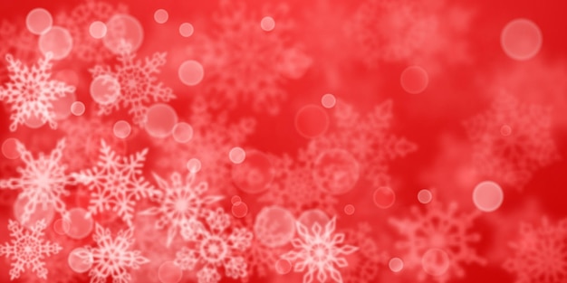 Christmas background of blurry snowflakes in red colors