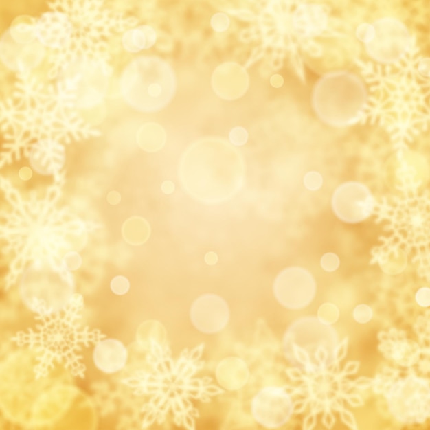 Christmas background of blurry snowflakes in yellow colors