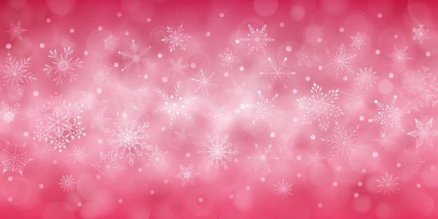 Christmas background of complex big and small falling snowflakes in red colors with bokeh effect