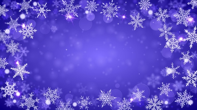 Christmas background of complex blurred and clear falling snowflakes in blue colors with bokeh effect