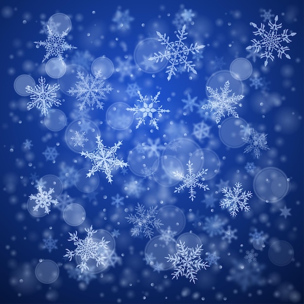 Christmas background of complex blurred and clear falling snowflakes in blue colors with bokeh effect