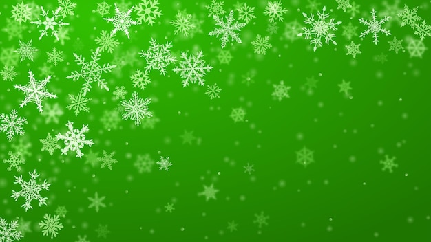 Christmas background of complex blurred and clear falling snowflakes in green colors with bokeh effect