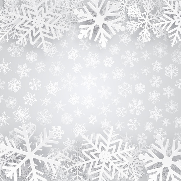 白い雪片と灰色のクリスマスの背景