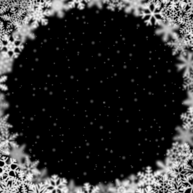 Christmas background of snowflakes of different shape blur and transparency arranged in a circle on black background