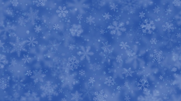 Christmas background of snowflakes of different shapes, sizes, blur and transparency in blue colors