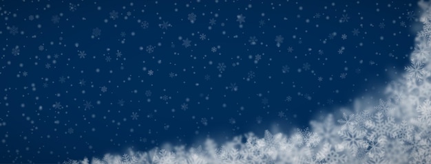 Christmas background of snowflakes of different shapes sizes blur and transparency on dark blue background