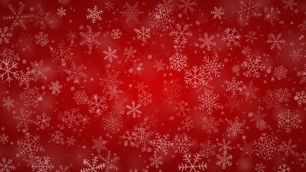 Christmas background of snowflakes of different shapes sizes and transparency in red colors