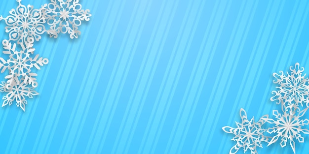 Christmas background with several paper snowflakes with soft shadows on light blue striped background