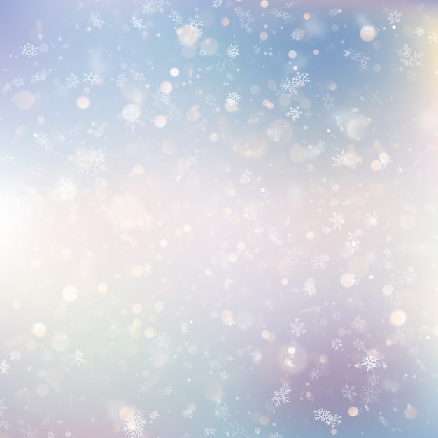 Christmas background with white blurred snowflakes.