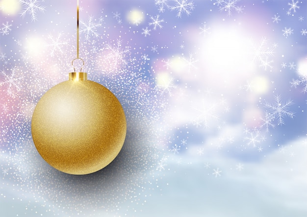 Christmas bauble on defocussed snowy landscape background