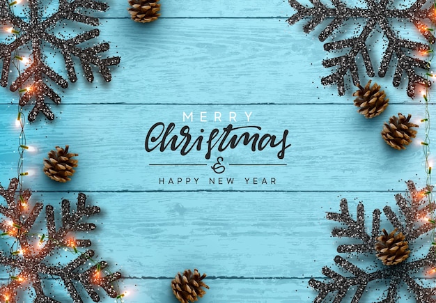 木製の背景にクリスマスの組成物。クリスマス装飾デザイン、スノーフレーク カラー ブラック、ゴールド ガーランド、松ぼっくり。青のリアルなウッド テクスチャ。フラットレイ、トップビュー。