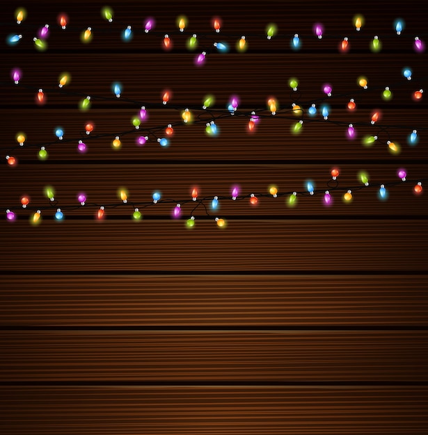 Vector christmas lights on wooden background