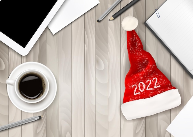 Christmas Office Background with Santa Hat with 2022, Tablet and Office Supplies. Business Concept. Vector.