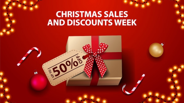 Christmas sales and discount week, red banner with gift box, christmas balls and candy cane, top view