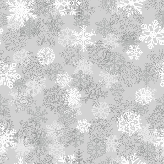 雪片のクリスマスのシームレスなパターン、灰色に白