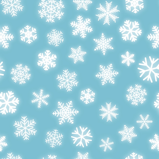 Christmas seamless pattern of white snowflakes of different shapes on light blue background