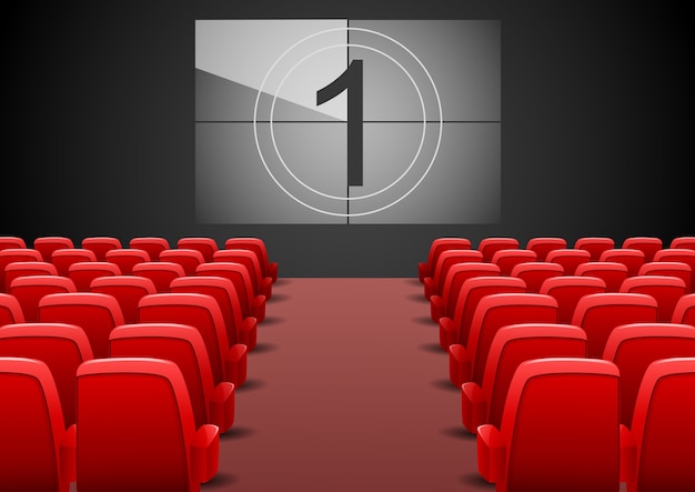 Cinema auditorium with red seats and film screen