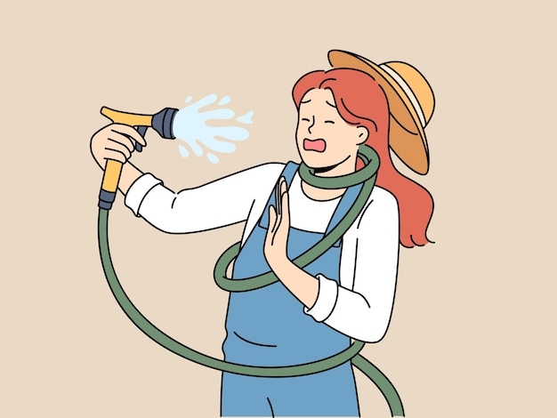 Clumsy woman with garden hose accidentally sprays herself with water while watering backyard lawn during drought Girl got tangled in garden hose due to failure or lack knowledge of safety precautions