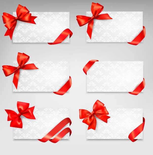 Collection of gift cards with red ribbons.  background