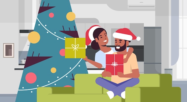 Vector couple holding gift boxes merry christmas happy new year holiday celebration concept man woman embracing wearing santa hats sitting on couch near fit tree modern living room interior horizontal vector