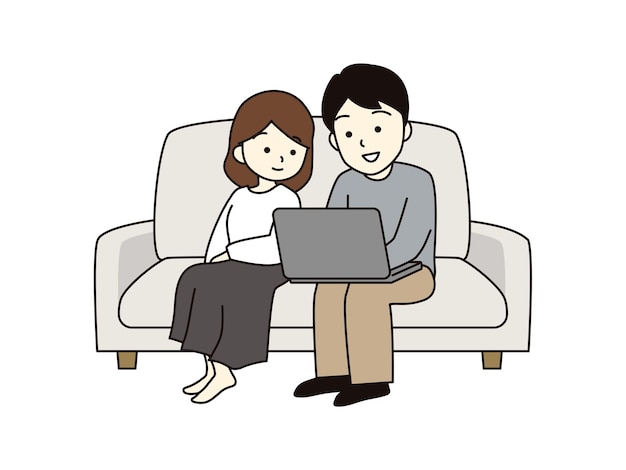 A couple sitting on the sofa and looking at a laptop