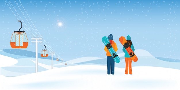 Couple snowboarders standing with snowboards.