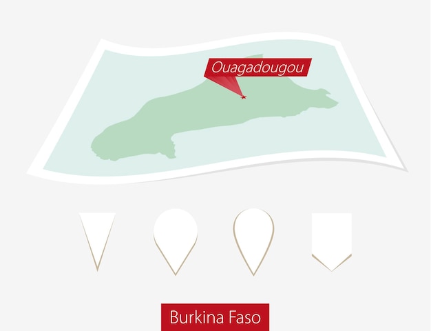 Vector curved paper map of burkina faso with capital ouagadougou on gray background four different map pin set vector illustration