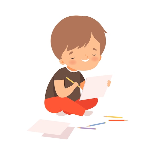 cute boy sitting on the floor and drawing picture with colorful pencils adorable young artist