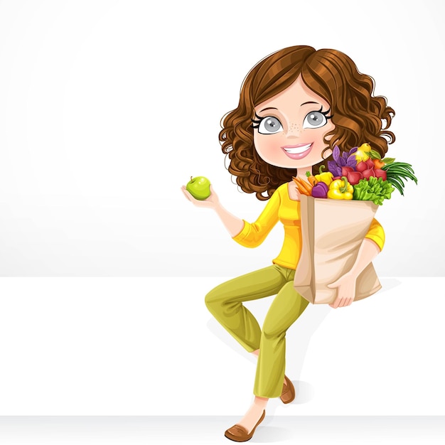 Cute brunette girl with paper bag fresh fruits and vegetables and green apple in hand sit on a white banner on white background