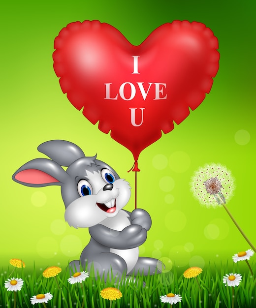 Симпатичный кролик, проведение красные сердца воздушные шары на зеленой траве