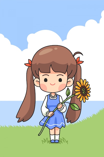 春に緑の野原に太陽の花を保持しているかわいい女の子