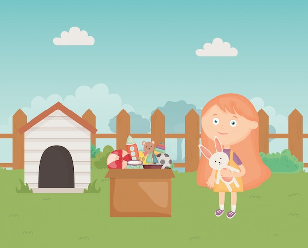 Cute girl with toys box and dog house in the backyard