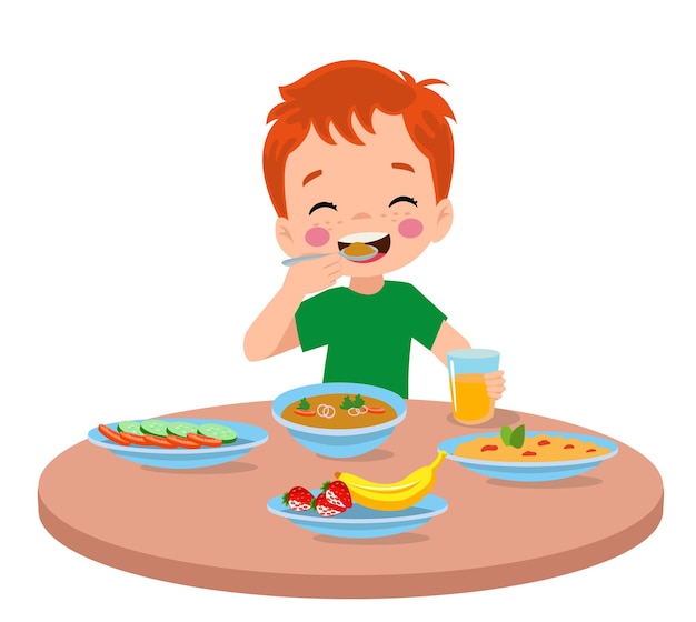 Cute little boy eating at the dinner table
