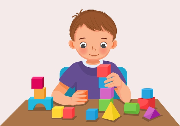 cute little boy playing colorful wooden brick block toys at the table