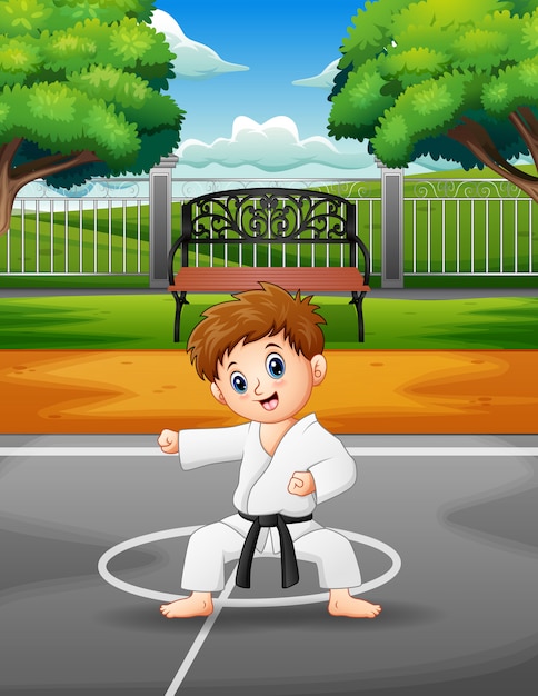 Cute little boy practicing karate in the outdoors