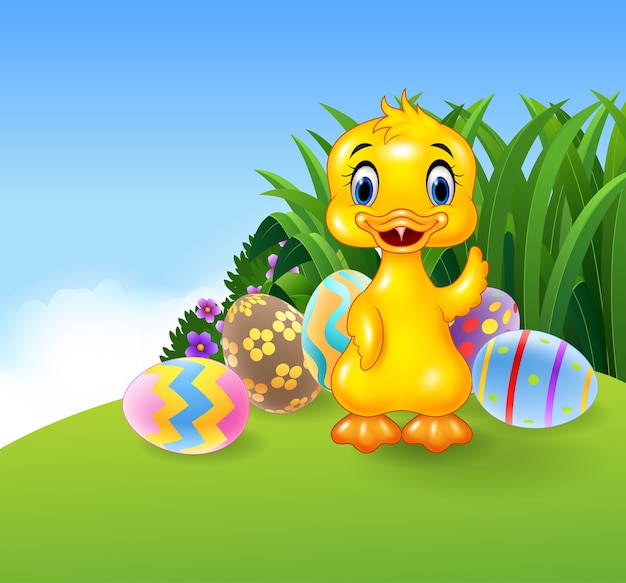 Cute little duck with colourful easter eggs