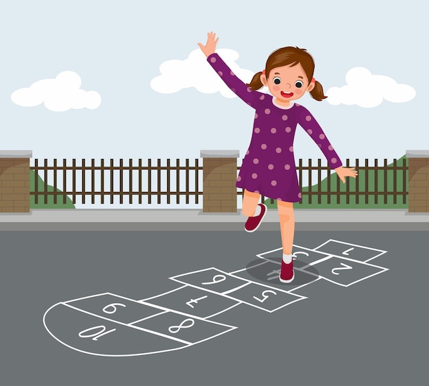 Cute little girl playing hopscotch drawn with chalk outside on playground street at the park