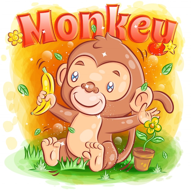 La piccola scimmia sveglia tiene una banana e una sensibilità felici