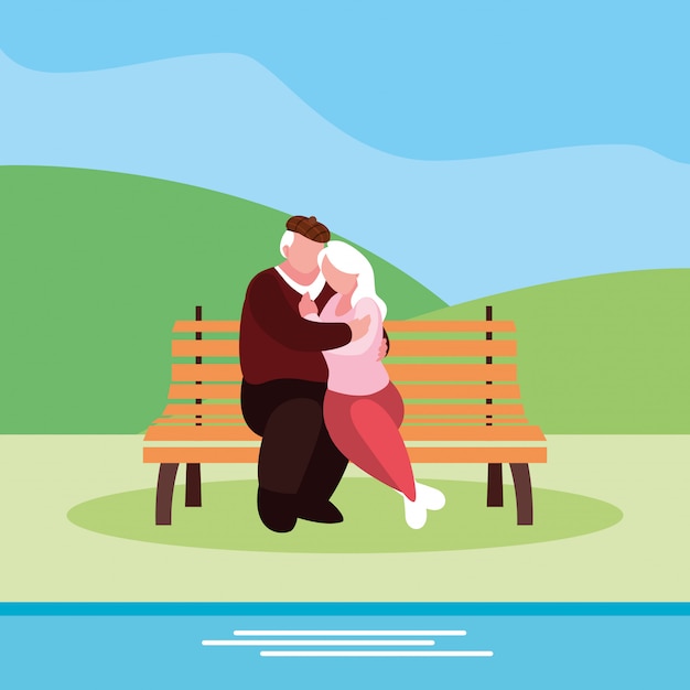 Cute old couple seated in chair of park