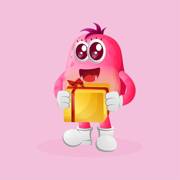 Cute pink monster holding gift box