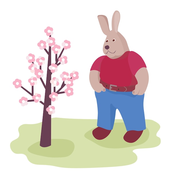 A cute rabbit stands in the garden near a flowering tree