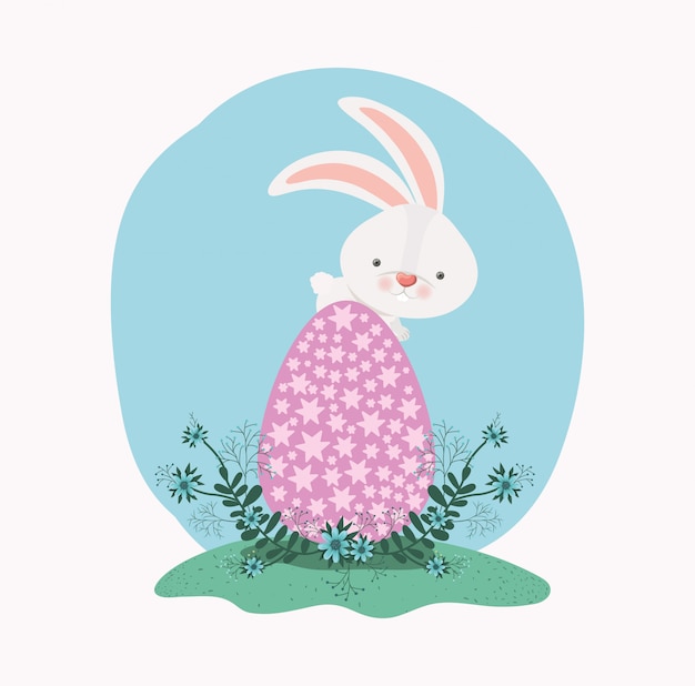 Cute rabbit with egg painted and flowers in the garden