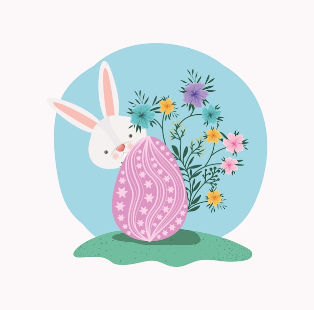 Cute rabbit with egg painted and flowers in the garden