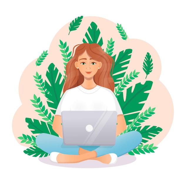 귀여운 빨간 머리 여자는 자연 속에 앉아 있는 동안 노트북에 앉아 있다